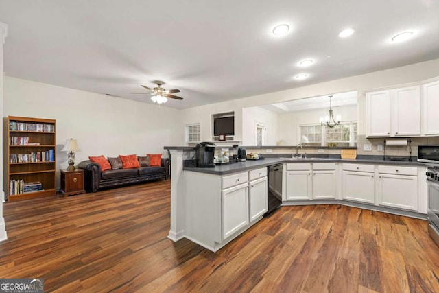 kitchen with sink, hanging light fixtures, appliances with stainless steel finishes, kitchen peninsula, and white cabinets