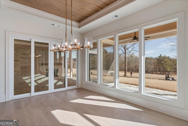 unfurnished dining area with wood ceiling, an inviting chandelier, a tray ceiling, and light hardwood / wood-style floors