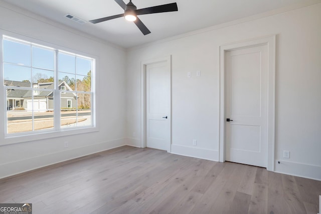 unfurnished bedroom featuring crown molding, ceiling fan, and light wood-type flooring