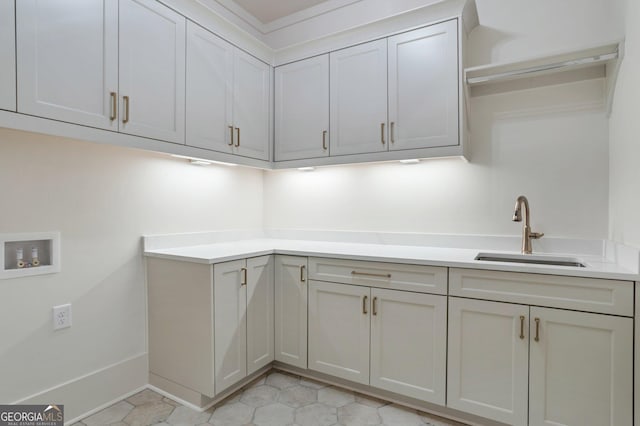 laundry room featuring cabinets, sink, and washer hookup