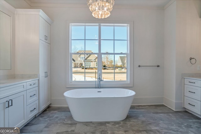 bathroom with vanity, a healthy amount of sunlight, a washtub, and ornamental molding