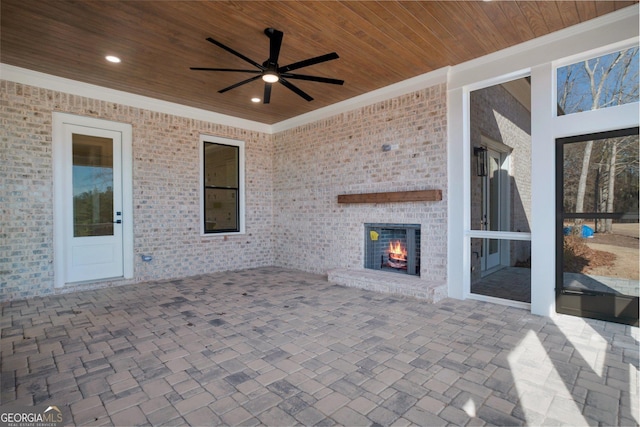 view of patio / terrace with an outdoor brick fireplace and ceiling fan