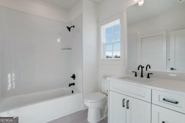 full bathroom with vanity, tiled shower / bath combo, and toilet