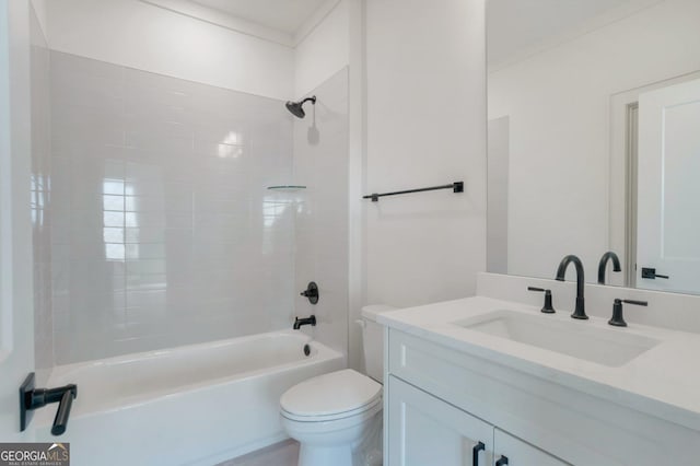 full bathroom featuring tiled shower / bath, vanity, and toilet