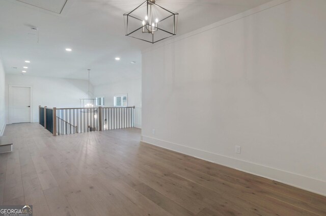 interior space featuring hardwood / wood-style flooring and a notable chandelier