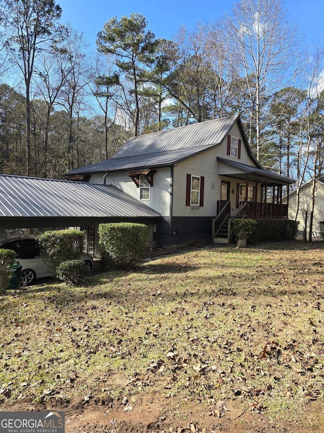 view of property exterior featuring a porch, a yard, and a carport