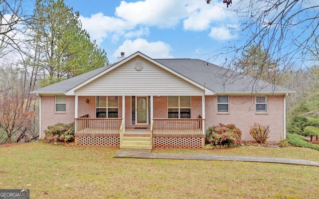 rear view of house with a lawn and covered porch