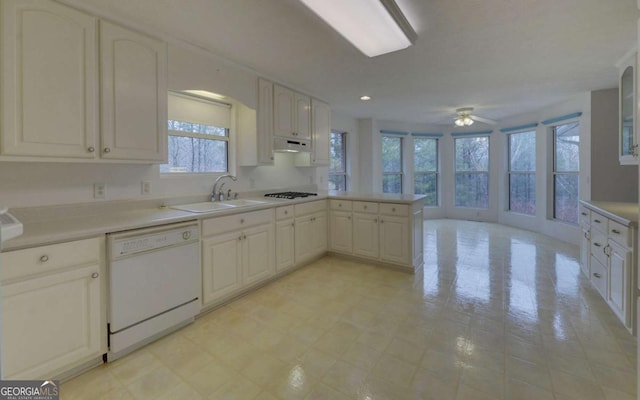 kitchen featuring sink, white cabinets, kitchen peninsula, and dishwasher