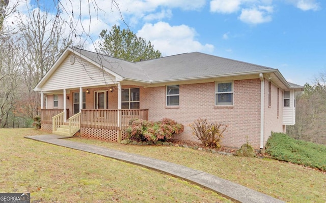 ranch-style house with a porch and a front yard