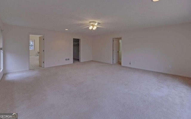 carpeted spare room with ceiling fan