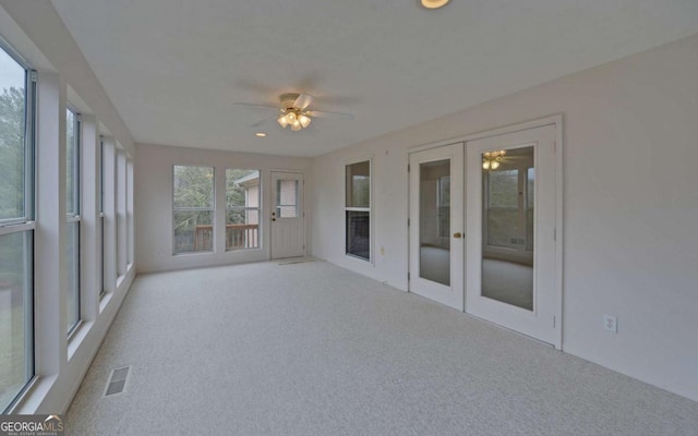 unfurnished sunroom featuring french doors and ceiling fan