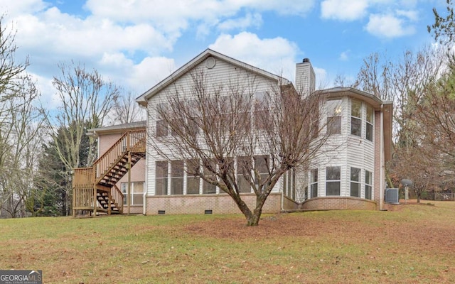 view of side of property featuring central AC unit and a lawn