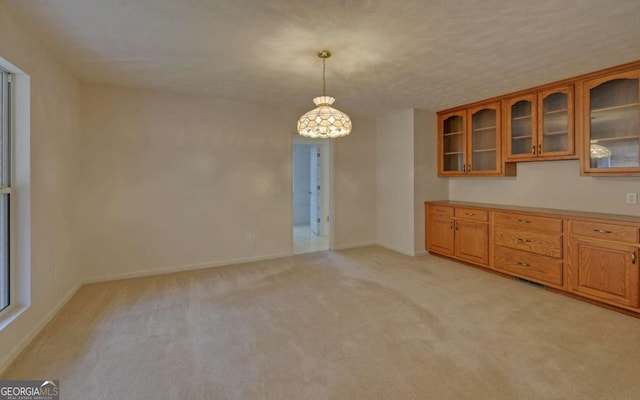 interior space with light carpet and a textured ceiling