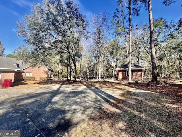 exterior space featuring driveway and brick siding