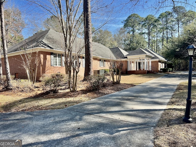 view of front of property featuring brick siding and driveway