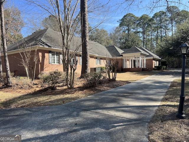 view of front of home featuring concrete driveway and brick siding