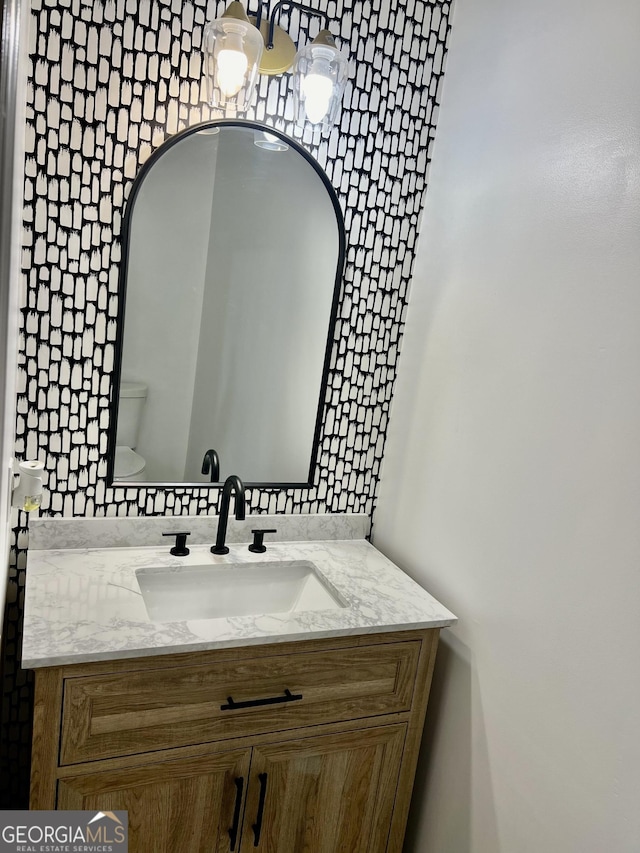 bathroom featuring toilet and vanity