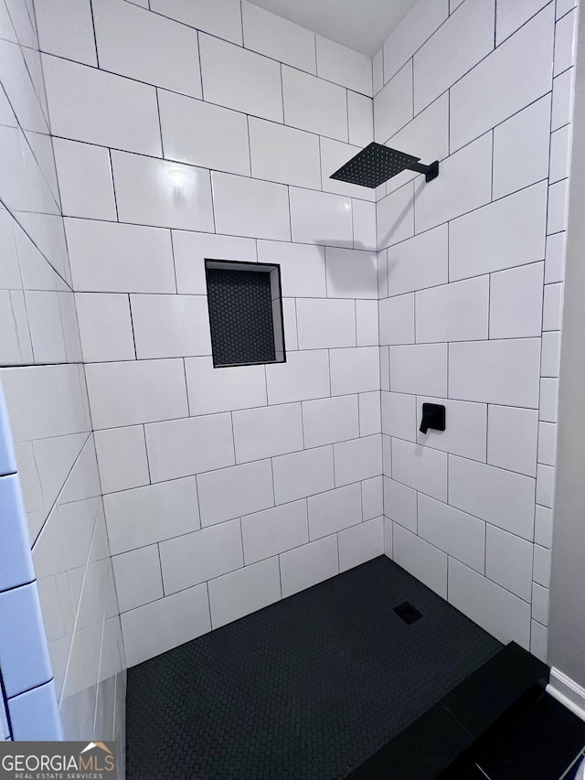 bathroom with tiled shower