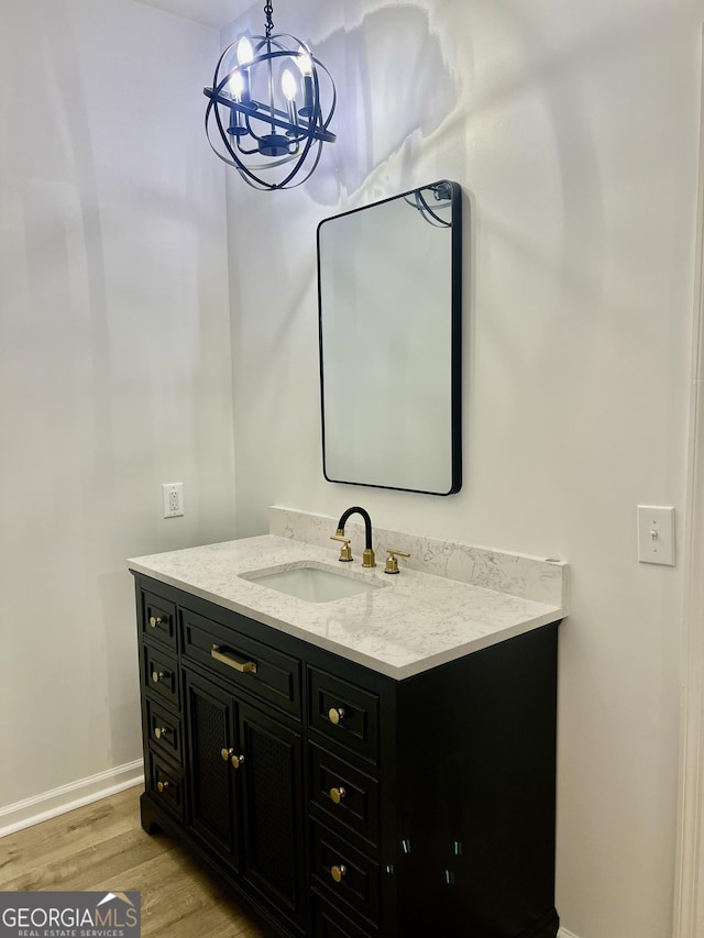 bathroom featuring wood finished floors, vanity, and baseboards