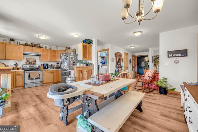 dining room with light hardwood / wood-style flooring and a chandelier