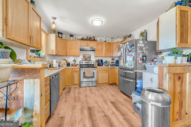 kitchen featuring light brown cabinetry, sink, light wood-type flooring, and appliances with stainless steel finishes