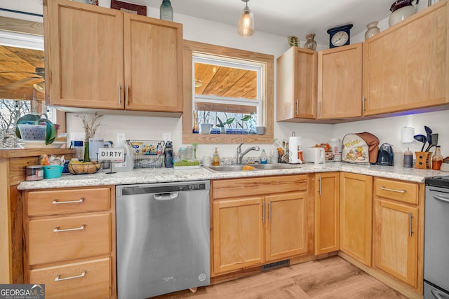 kitchen featuring sink, light brown cabinets, light hardwood / wood-style floors, and appliances with stainless steel finishes