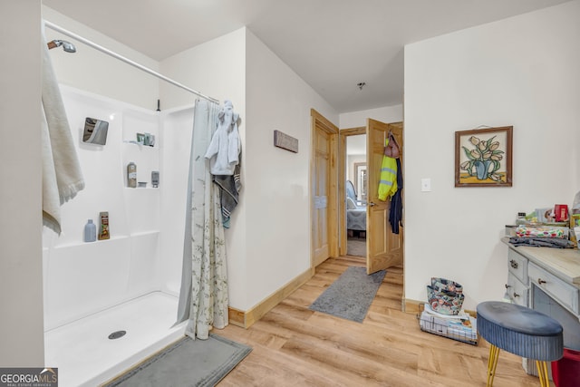 bathroom featuring a shower with curtain, vanity, and hardwood / wood-style flooring