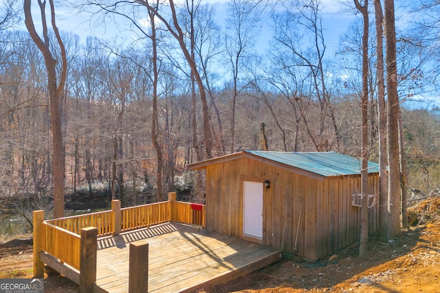 wooden terrace featuring an outdoor structure