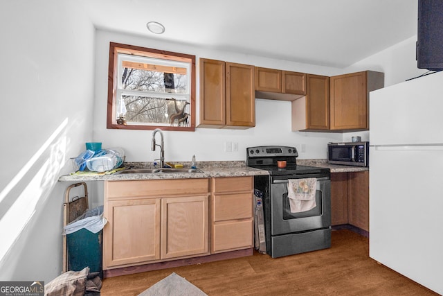 kitchen featuring appliances with stainless steel finishes, sink, and hardwood / wood-style floors