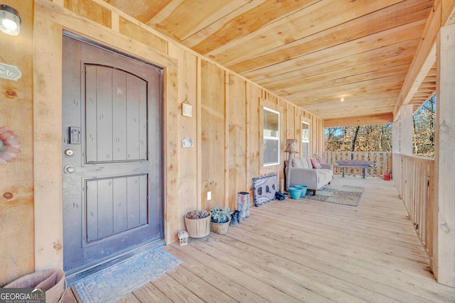 wooden terrace featuring covered porch