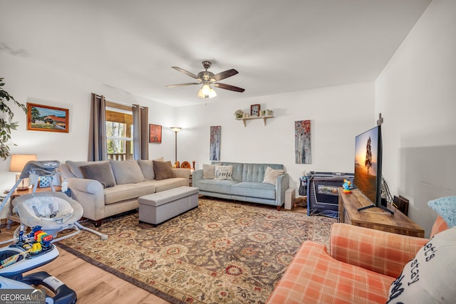 living room with wood-type flooring and ceiling fan