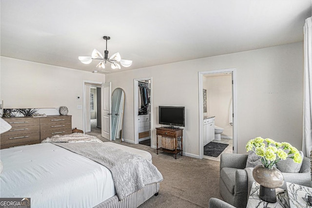 bedroom featuring ensuite bathroom, a chandelier, a walk in closet, carpet, and a closet