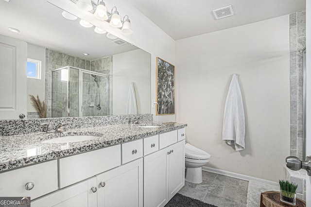 bathroom with vanity, toilet, and a shower with shower door