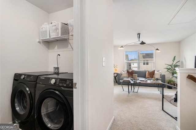 clothes washing area featuring washer and clothes dryer and carpet flooring