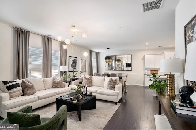 living room featuring a notable chandelier and light hardwood / wood-style floors