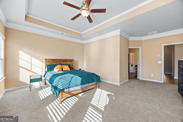 bedroom featuring a raised ceiling, crown molding, light carpet, and ceiling fan