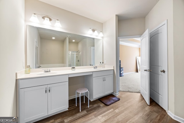 bathroom with vanity, hardwood / wood-style floors, and walk in shower