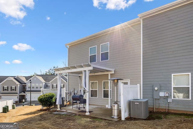 back of house featuring a pergola and central air condition unit