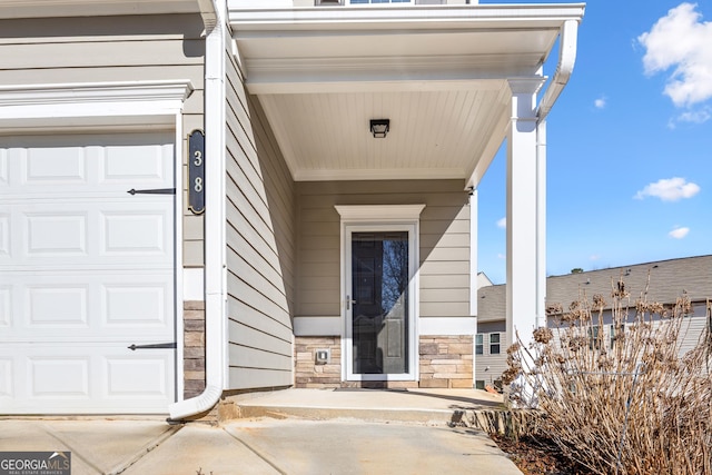 view of exterior entry featuring a garage