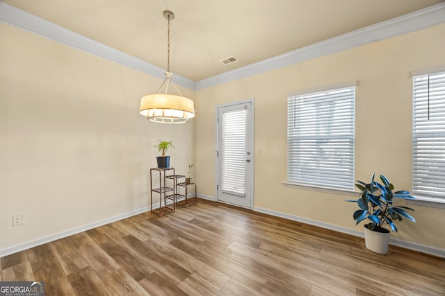 entrance foyer with crown molding and hardwood / wood-style flooring