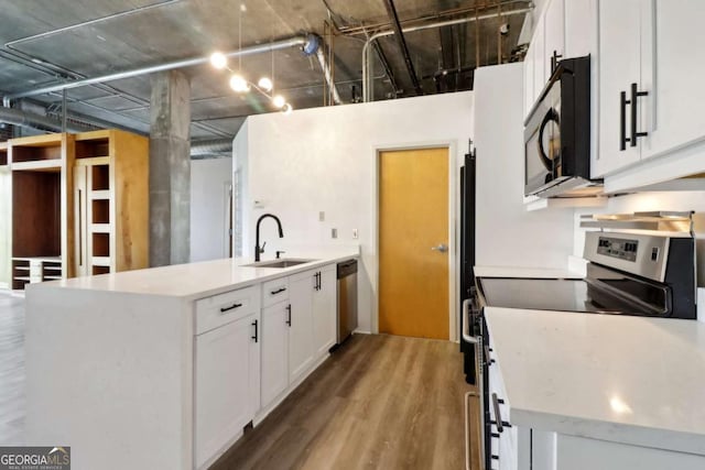 kitchen featuring white cabinetry, an island with sink, stainless steel appliances, and sink