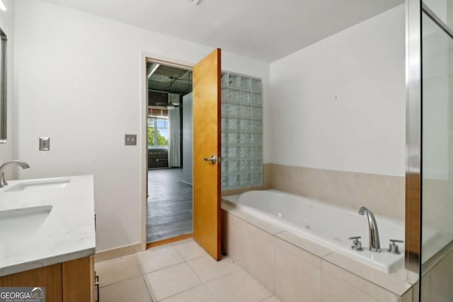 bathroom with vanity, tile patterned floors, and tiled bath