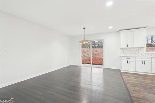 unfurnished dining area featuring dark hardwood / wood-style floors