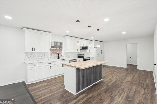 kitchen with white cabinetry, sink, range with electric stovetop, and a center island