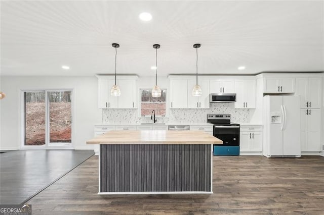 kitchen featuring white cabinetry, stainless steel appliances, a center island, and hanging light fixtures