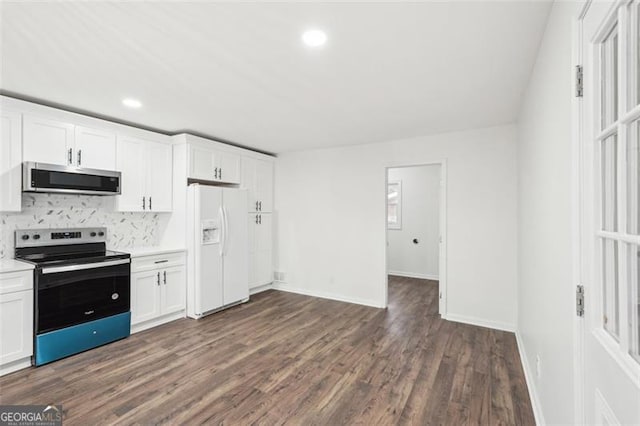 kitchen with stainless steel appliances, white cabinetry, dark hardwood / wood-style floors, and backsplash