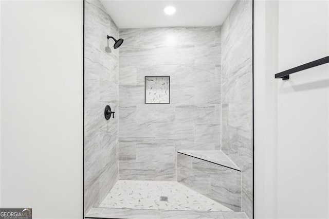 bathroom with tiled shower