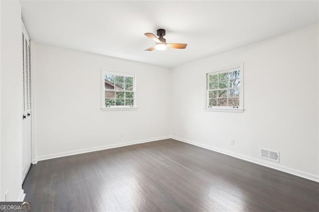 empty room featuring dark hardwood / wood-style floors and ceiling fan