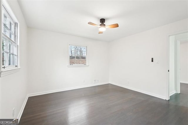 empty room featuring dark hardwood / wood-style flooring and ceiling fan