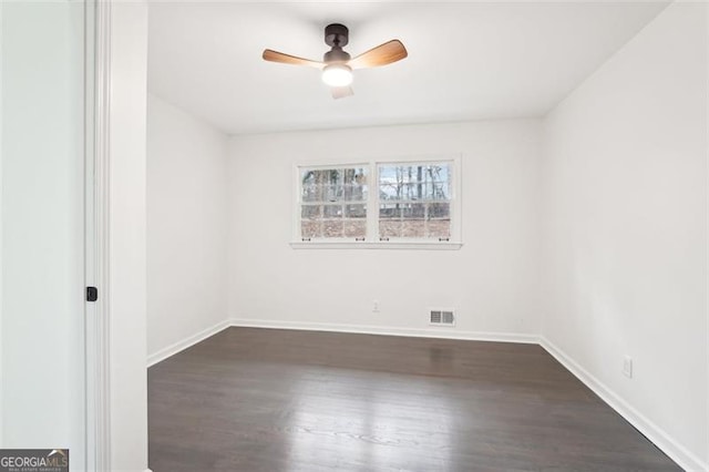 empty room featuring ceiling fan and dark hardwood / wood-style flooring